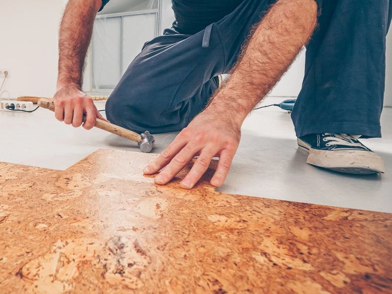 Person installing cork flooring from Adair's Brunnerville Flooring in the Lititz, PA area