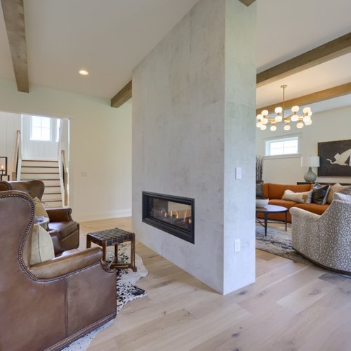 Contemporary double sided fireplace by Adair's Flooring