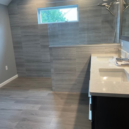 Bathroom with slate grey LVT floors and walls