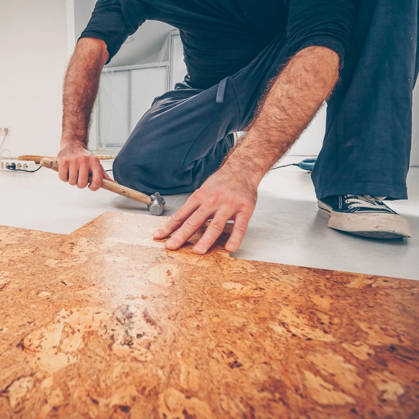 Person installing cork flooring from Adair's Brunnerville Flooring in the Lititz, PA area