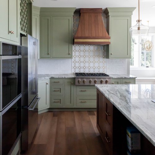 Beautiful kitchen with sage green cabinets and gold kitchen backsplash